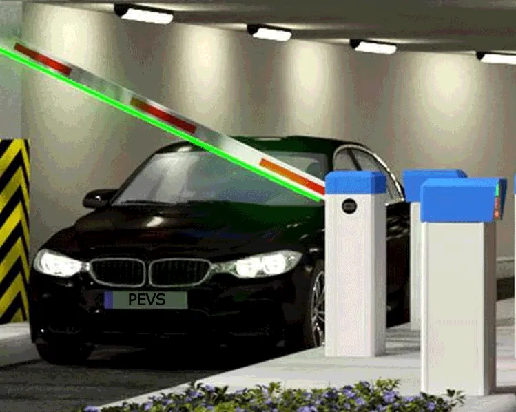 Geöffnete Schrankenanlage mit Ein- und Ausfahrtsäulen an einer beleuchteten Tiefgaragenzufahrt, davor ein wartendes Fahrzeug